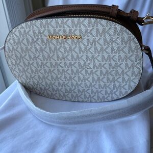 NWT - Michael Kors Cream MK Logo Oval Crossbody with Brown Leather Trim.